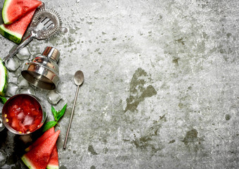 Watermelon cocktail with mint and ice in a shaker.
