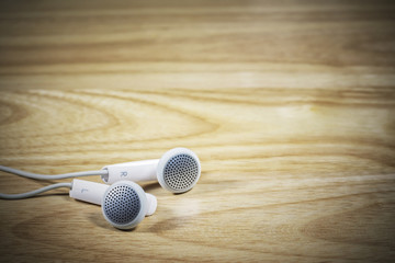Headphone or earphone  on wooden background.