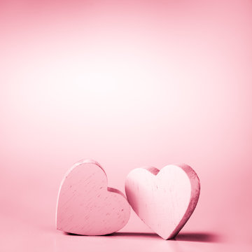 Two pink hearts on a pink background