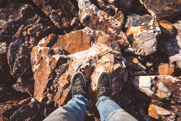 Looking down on feet and a wooden surface, space for text. selective focus