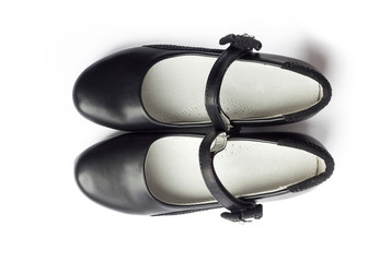 Pair of black shoes for girl on white background