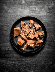 The chunks of chocolate on the old plate.