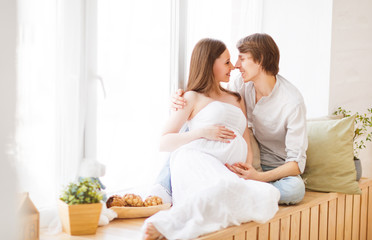 Obraz na płótnie Canvas pregnancy. happy family future parents pregnant mother and fathe