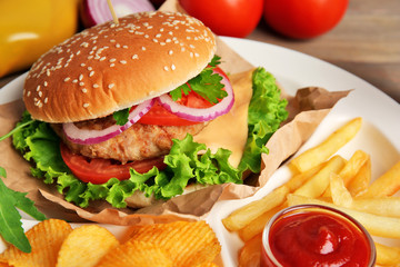 Tasty cheeseburger with fries and ketchup, closeup