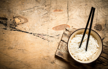 Fototapeta na wymiar Boiled rice with chopsticks.