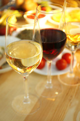 Glasses of different wine on wooden table