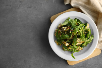 Tasty salad with chicken, cucumbers and arugula on plate