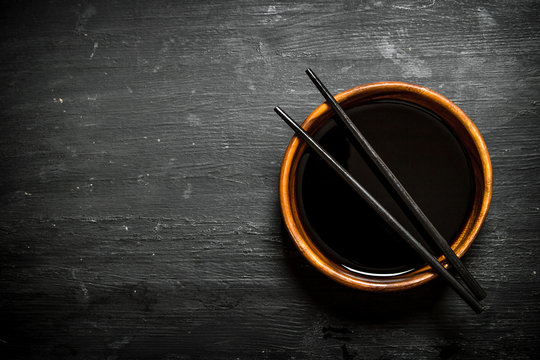 Soy Sauce In A Bowl And Chopsticks.