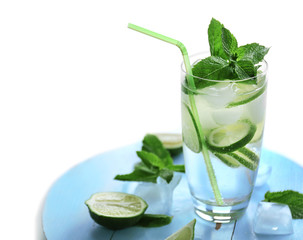 Cold fresh cocktail with lime on board on light background