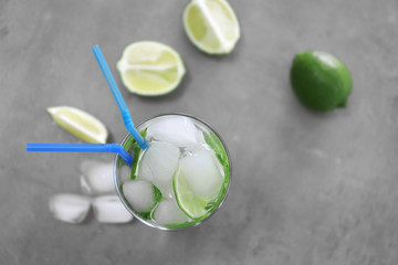 Cold fresh cocktail with lime on light background