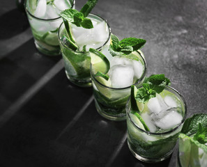 Cold fresh cocktails with lime on grey background