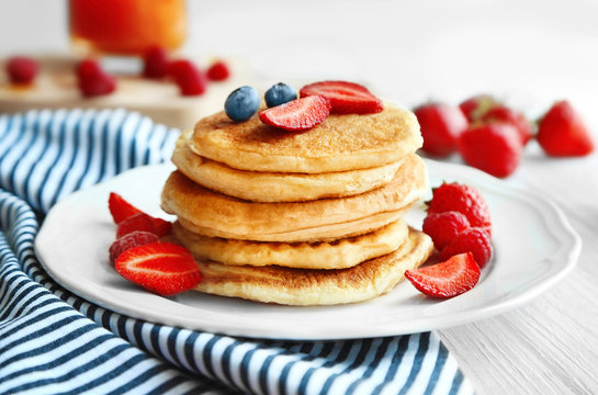 Tasty pancakes with fresh berries on plate