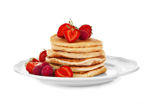 Tasty pancakes with fresh berries on plate, isolated on white