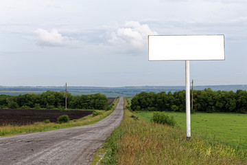 Blank empty billboard on roadside with copyspace. Shallow focus.