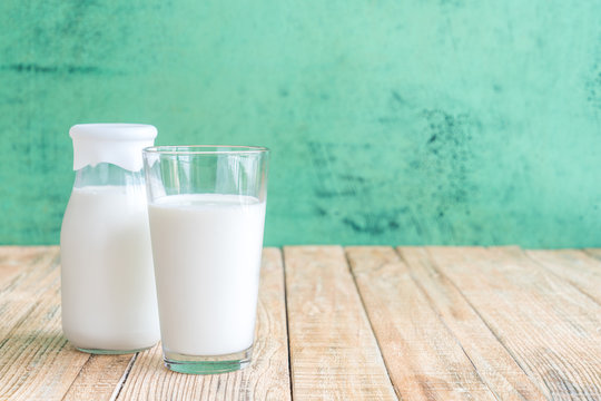milk on a wooden table on Green background