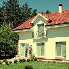 white house with green lawn and blue sky