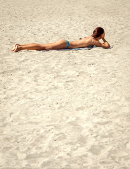 young woman on beach in bikini