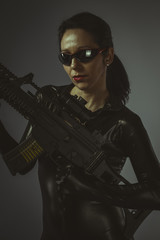 Fototapeta na wymiar Killer, Sexy girl military woman posing with guns.