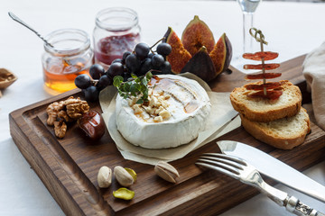 baked camambert cheese with jam decorated  almond