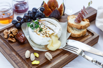 baked camambert cheese with jam decorated  almond
