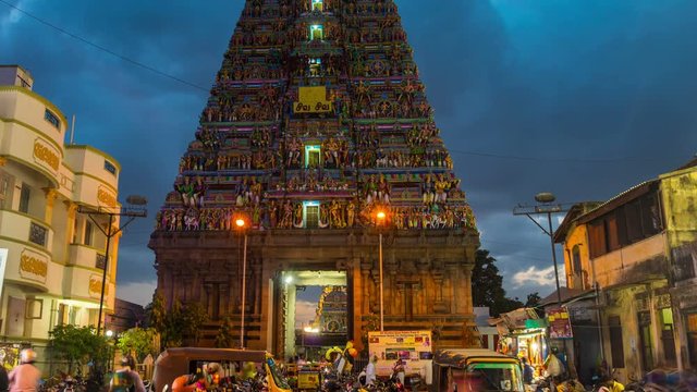 Famous Arulmigu Kapaleeswarar Temple in Chennai, Tamil Nadu, India at night. Time-lapse of illuminated entrance with nightlife around