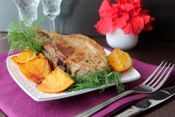 pork chop on the bone with oranges