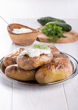 Baked potato topped with sour cream sauce