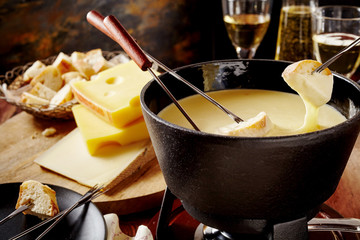 Swiss cheese fondue, a popular national dish - obrazy, fototapety, plakaty