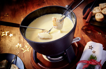 Dipping bread into a delicious cheese fondue