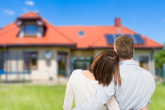 Young couple looking at dream house.