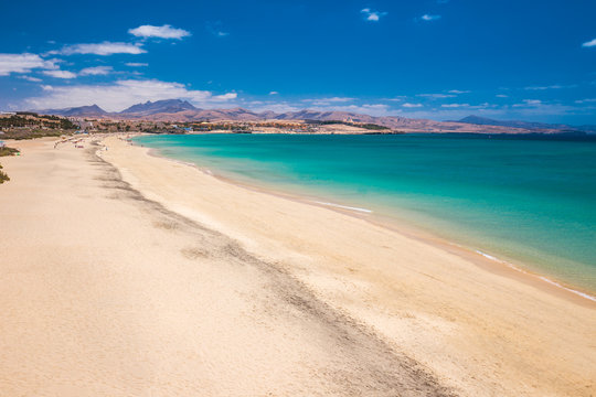 Costa Calma sandy beach with vulcanic mountains in the background, Jandia,  Fuerteventura island, Canary Islands, Spain.