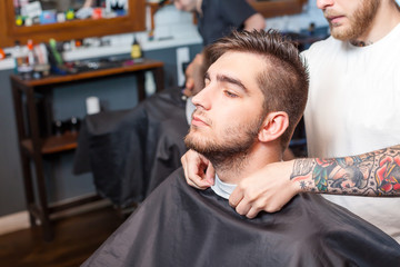 Young man having hair cutted