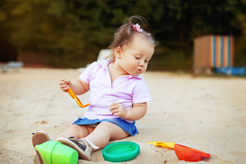 funny little kid playing in the sand. Top view. The concept of childhood and development.