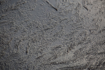 Black water with alga making textured reflections.