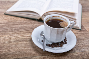 A cup of coffee with a book