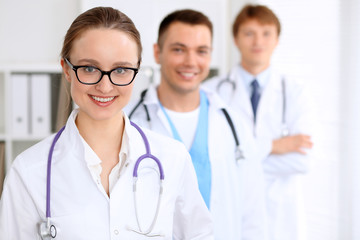 Fototapeta premium Happy doctor woman with medical staff at the hospital