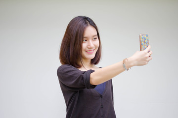 Portrait of thai adult student university beautiful girl using her smart phone Selfie