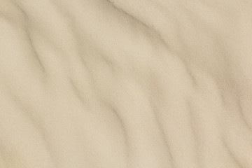 Fototapeta na wymiar closeup of sand pattern of a beach in the summer soft focus