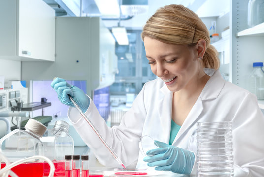 Young European female scientist or tech works in laboratory