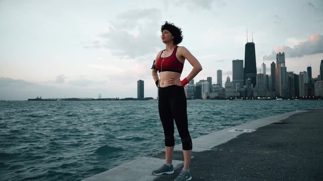 Runner athlete taking a breath and smiling at seaside