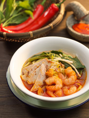 Penang Prawn Mee soup with pork, vegetables, red chili and shrim