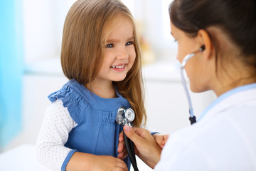 Doctor examining a little girl by stethoscope