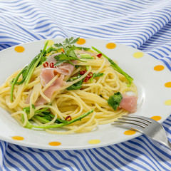 Pasta noodle with sauteed pork and vegetables on the tablecloth