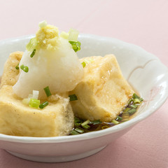 Fried tofu with onion sauce on white bowl