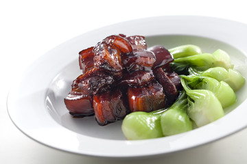 Sweet and Sour sauteed pork ribs with cabbage on white platter