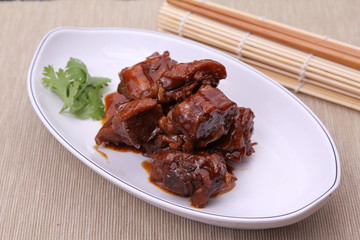 Chinese style of deep fried chicken on white plate on bamboo tra