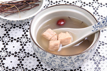 Stewed soup of pork in bowl in chinese style with herbs