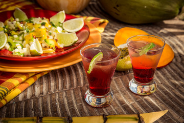 Red glasses of fruit cocktail in Thai style with orange coconut