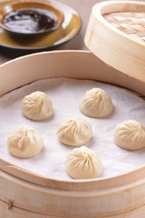 Fototapeta na wymiar Durian Xiao Long Bao or Chinese dumplings in bamboo tray