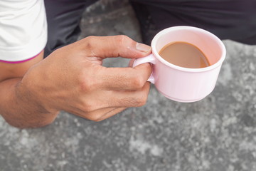 Young man holding a cup of coffee